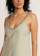 Detail shot of naturally dyed pom pom detail on sage green tank top