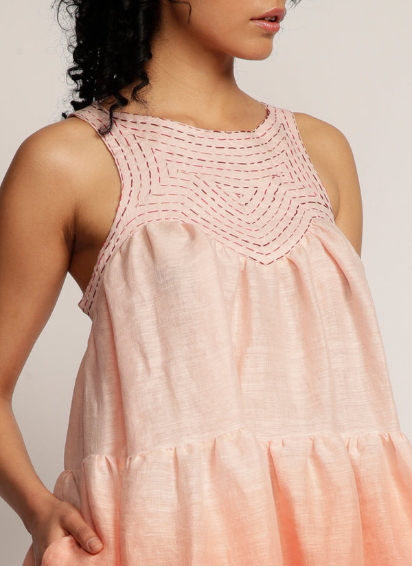 Close up of hand embroidered detail on dip-dyed pink sleeveless dress