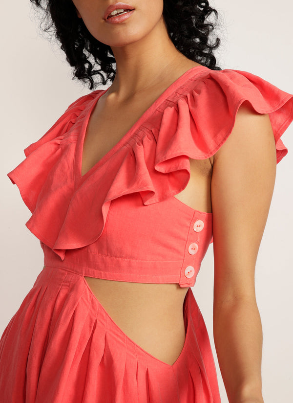 Close up of ruffle detail and shell button side of pink maxi dress